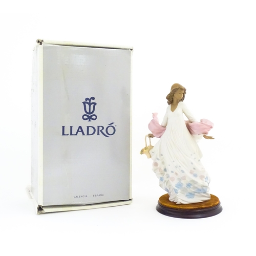 136 - A Lladro figure titled Spring Splendor, model no. 2325. With box and circular wooden stand. Approx. ... 