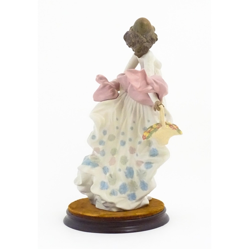 136 - A Lladro figure titled Spring Splendor, model no. 2325. With box and circular wooden stand. Approx. ... 