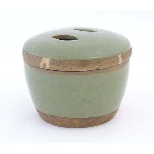 16 - A Chinese celadon pot and cover. Character marks under. Approx. 5 1/2