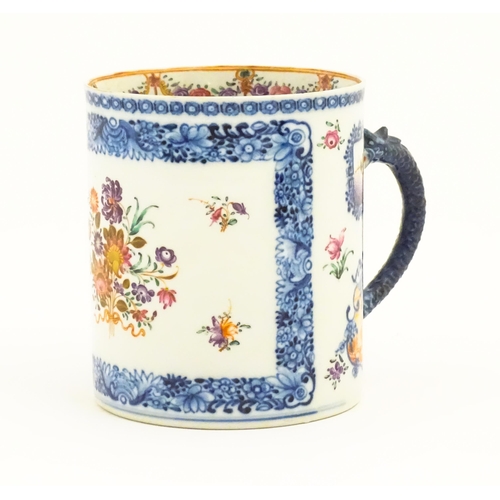 242A - A Chinese Export famille rose tankard decorated with floral and foliate sprays within blue borders, ... 