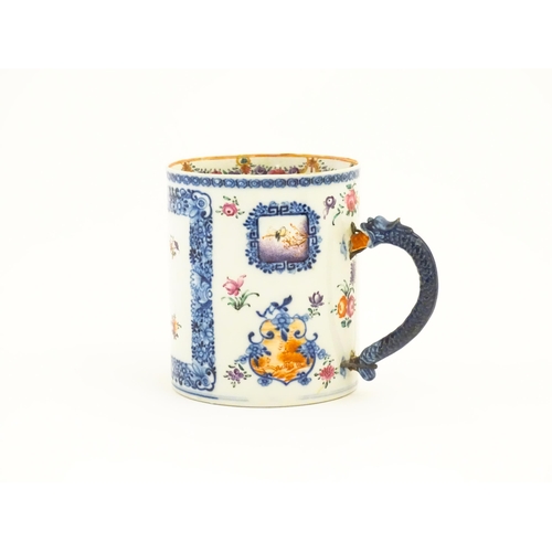 242A - A Chinese Export famille rose tankard decorated with floral and foliate sprays within blue borders, ... 