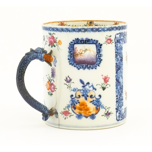 242A - A Chinese Export famille rose tankard decorated with floral and foliate sprays within blue borders, ... 