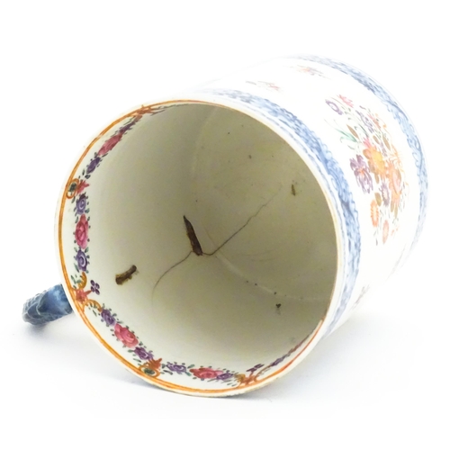 242A - A Chinese Export famille rose tankard decorated with floral and foliate sprays within blue borders, ... 