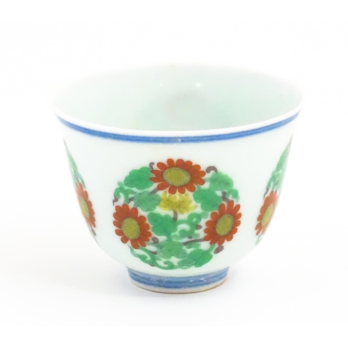 37 - A Chinese wine cup decorated with floral roundels. Character marks under. Approx. 1 3/4