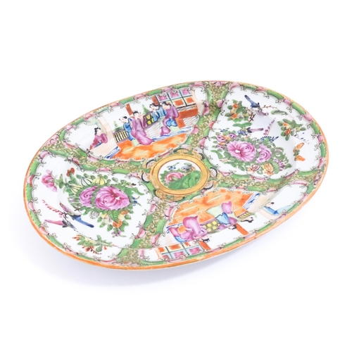 42 - A Chinese / Cantonese famille rose plate / dish of oval form decorated with four panels, two depicti... 