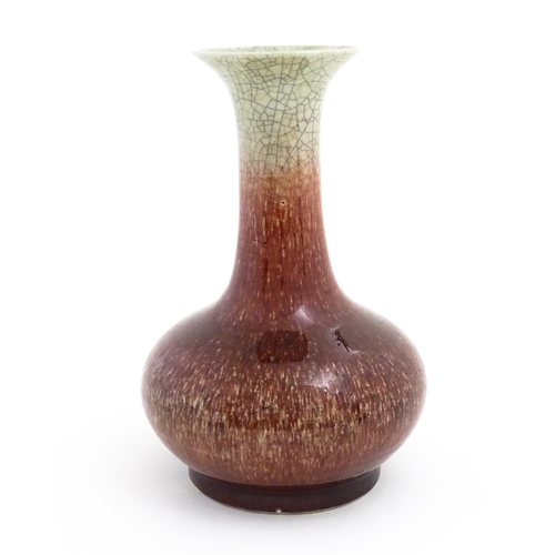 46 - A Chinese sang de boeuf vase with a flared rim and crackle glaze. Indistinctly marked under. Approx.... 