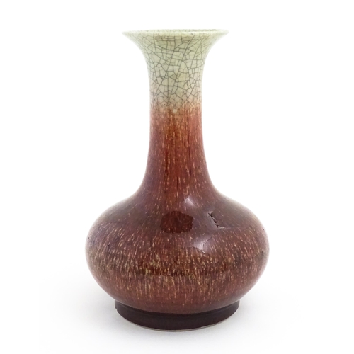 46 - A Chinese sang de boeuf vase with a flared rim and crackle glaze. Indistinctly marked under. Approx.... 