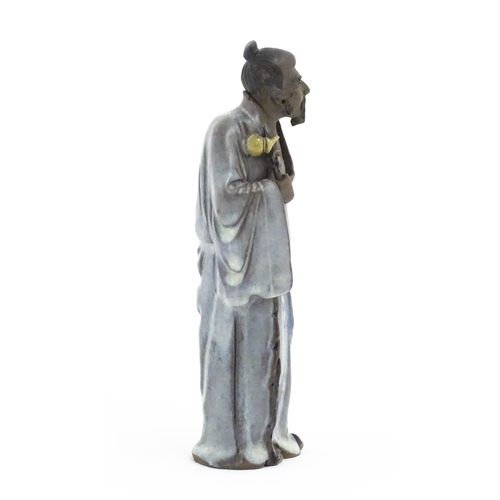 51 - A Chinese mud man figure depicted wearing robes. Approx. 7 1/4