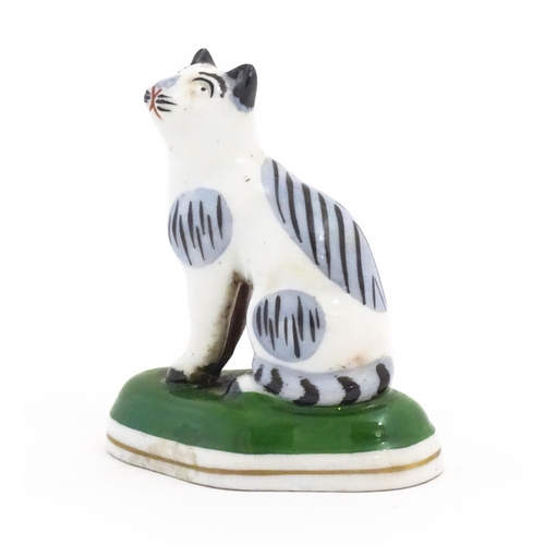 62 - A Chelsea style model of a seated cat. Gold anchor mark under. Approx. 2 1/2