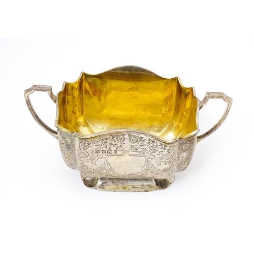 314 - A silver sugar basin with twin handles, engraved foliate detail and gilded interior. Hallmarked Shef... 