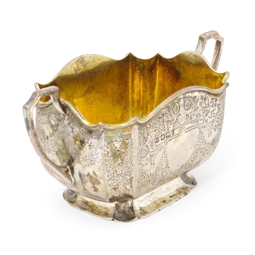 314 - A silver sugar basin with twin handles, engraved foliate detail and gilded interior. Hallmarked Shef... 