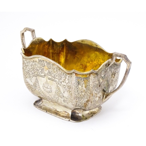 314 - A silver sugar basin with twin handles, engraved foliate detail and gilded interior. Hallmarked Shef... 