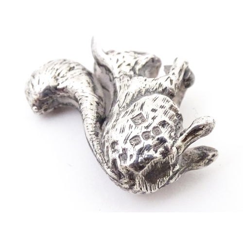 327 - A miniature silver model of a seated squirrel with a nut, hallmarked London 1976. Approx. 1