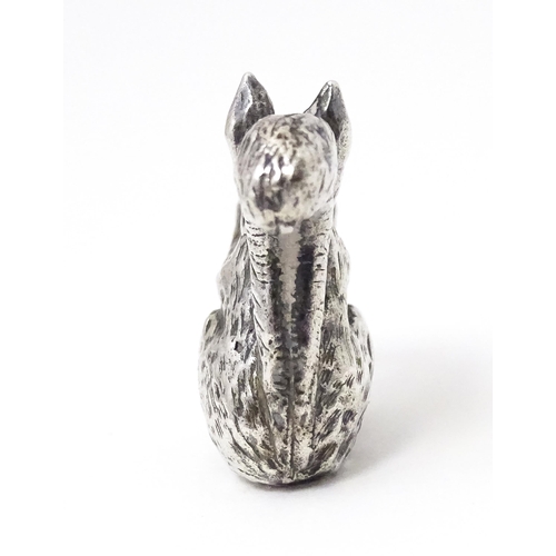 327 - A miniature silver model of a seated squirrel with a nut, hallmarked London 1976. Approx. 1