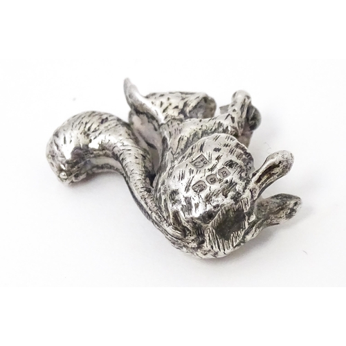 327 - A miniature silver model of a seated squirrel with a nut, hallmarked London 1976. Approx. 1