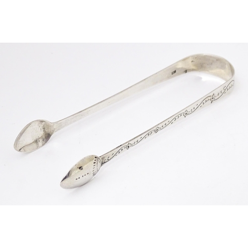 329 - Geo III silver sugar tongs with bright cut decoration, hallmarked London 1805, maker Stephen Adams. ... 