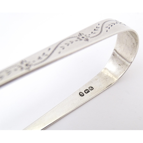 329 - Geo III silver sugar tongs with bright cut decoration, hallmarked London 1805, maker Stephen Adams. ... 