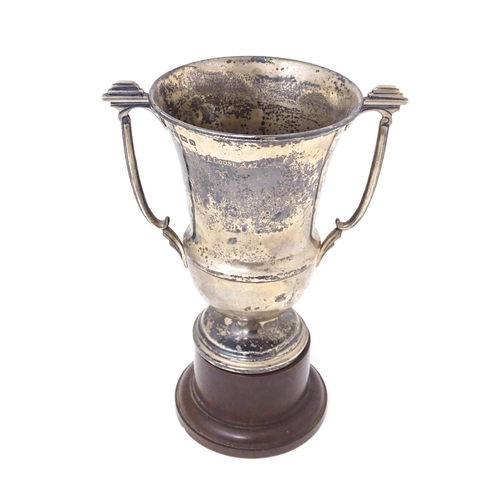 331 - An Art Deco silver trophy cup with twin handles. Hallmarked Birmingham 1937 maker A E Poston & Co Lt... 