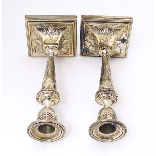 333 - A pair of silver candlesticks with harebell swag and bow decoration. Hallmarked Sheffield 1909 maker... 