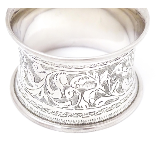 343 - A silver napkin ring with engraved acanthus scroll decoration, hallmarked Birmingham 1906