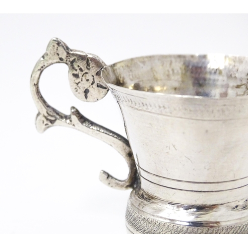 344 - A Continental silver tot cup with scroll handle, possibly Austrian. Approx. 1 1/2