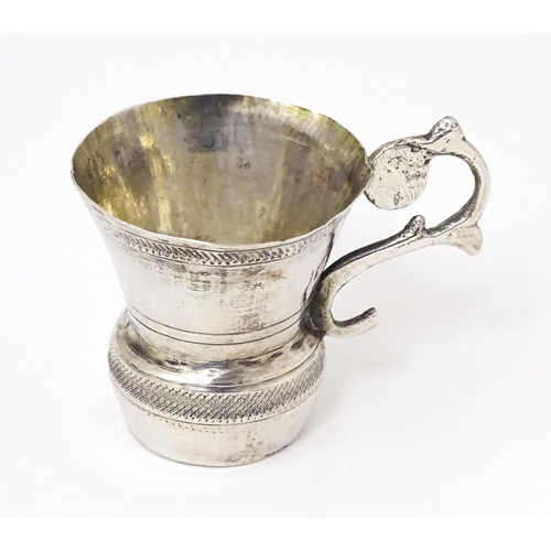 344 - A Continental silver tot cup with scroll handle, possibly Austrian. Approx. 1 1/2