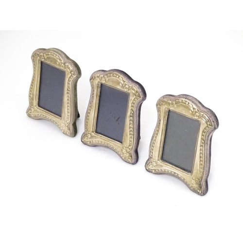 377 - A set of three photograph frames with easel backs and silver surrounds. Hallmarked Birmingham 1986 m... 