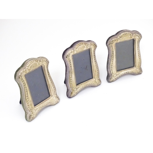 377 - A set of three photograph frames with easel backs and silver surrounds. Hallmarked Birmingham 1986 m... 