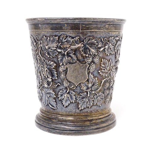 378 - A Victorian silver mug with hop and vine decoration, branch formed handle and gilded interior. Hallm... 