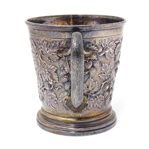 378 - A Victorian silver mug with hop and vine decoration, branch formed handle and gilded interior. Hallm... 