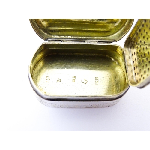 387 - An early 19thC silver gilt vinaigrette of oval form opening to reveal a pierced grill, hallmarked Bi... 