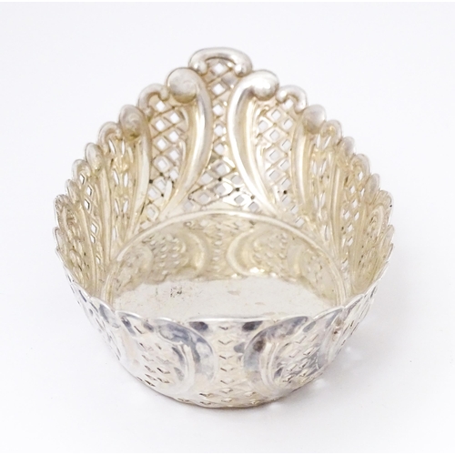 388 - A Victorian silver sweet meat dish of oval form with pierced and embossed decoration. hallmarked She... 