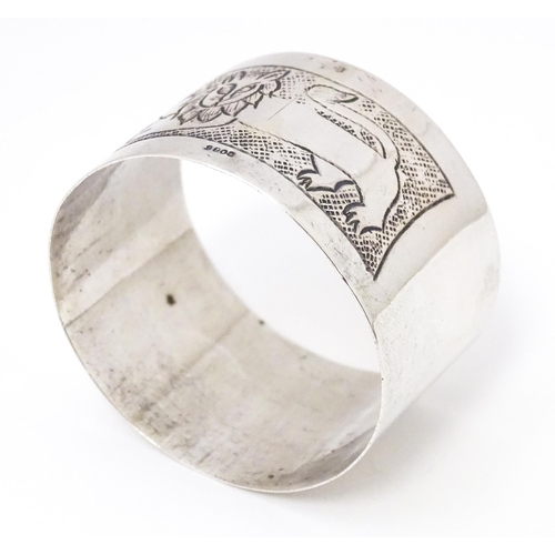 396 - A Continental silver napkin ring with engraved lion decoration, marked S800.