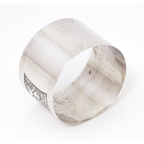 396 - A Continental silver napkin ring with engraved lion decoration, marked S800.