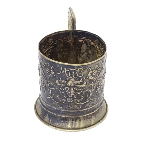 397 - A Continental white metal tisane beaker holder . With floral and foliate detail. Indistinctly marked... 