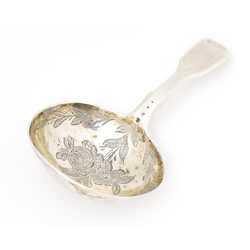 415 - A Victorian silver caddy spoon with engraved decoration to bowl. Hallmarked London 1864 maker Charle... 