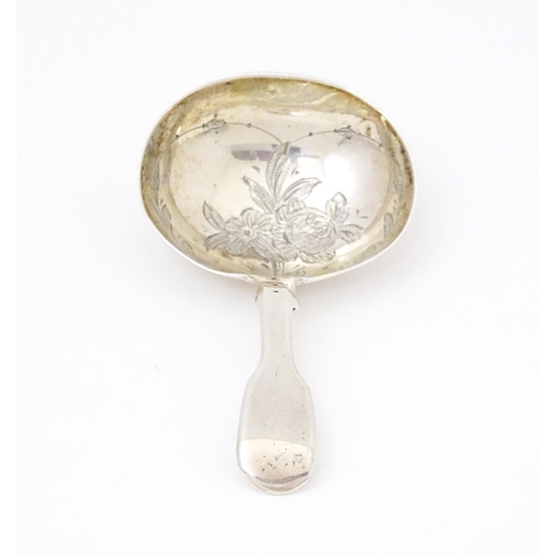 415 - A Victorian silver caddy spoon with engraved decoration to bowl. Hallmarked London 1864 maker Charle... 