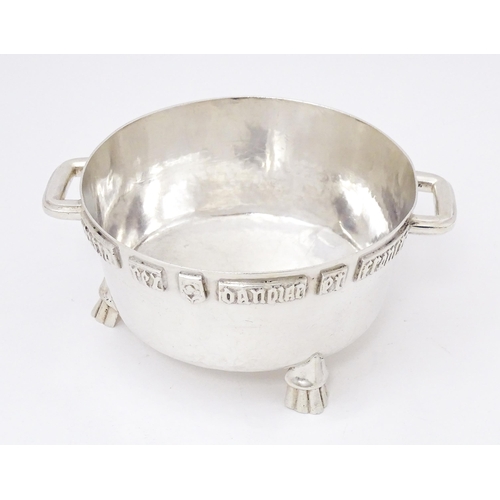 420 - A silver Arts and Crafts style bowl modelled as The Winchester Bushel, with hammered decoration, app... 