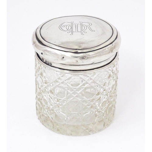 434 - A cut glass dressing table jar with silver lid hallmarked Birmingham 1910, maker Synyer & Beddoes. A... 