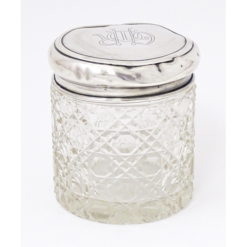 434 - A cut glass dressing table jar with silver lid hallmarked Birmingham 1910, maker Synyer & Beddoes. A... 