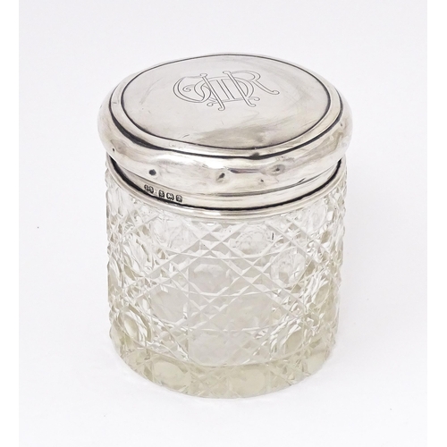 434 - A cut glass dressing table jar with silver lid hallmarked Birmingham 1910, maker Synyer & Beddoes. A... 