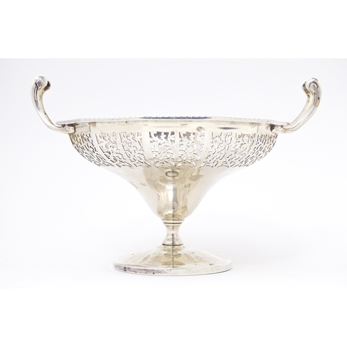 444 - A pair of silver bon bon dished of pedestal form with pierced decoration and twin handles. Hallmarke... 