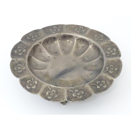 450 - A Mexican silver dish with floral detail and raised on three ball and claw feet. Marked under Mexico... 