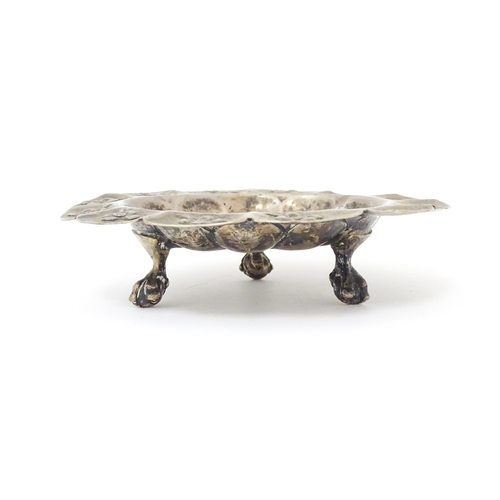 450 - A Mexican silver dish with floral detail and raised on three ball and claw feet. Marked under Mexico... 