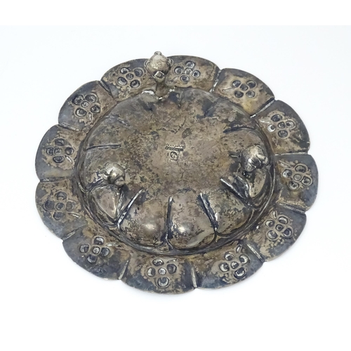 450 - A Mexican silver dish with floral detail and raised on three ball and claw feet. Marked under Mexico... 