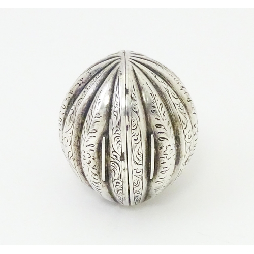 451 - A Victorian silver nutmeg grater of melon form with engraved detail. Hinging open to reveal grater w... 