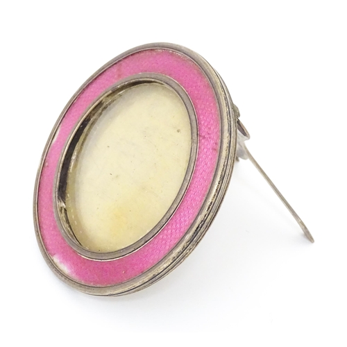 458 - A silver easel back photograph frame of circular form with pink guilloche enamel decoration. Hallmar... 