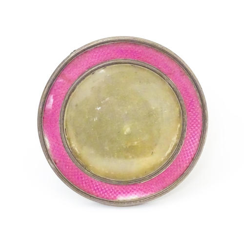 458 - A silver easel back photograph frame of circular form with pink guilloche enamel decoration. Hallmar... 