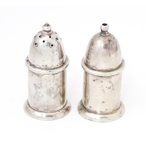 463 - A pair of silver plate pepperettes stamped under Mappin & Webb. 2 3/4