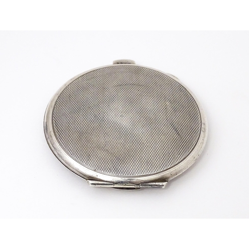 475 - A Silver compact with engine turned decoration. Hallmarked Birmingham 1965 maker Garrard & Co Ltd. A... 